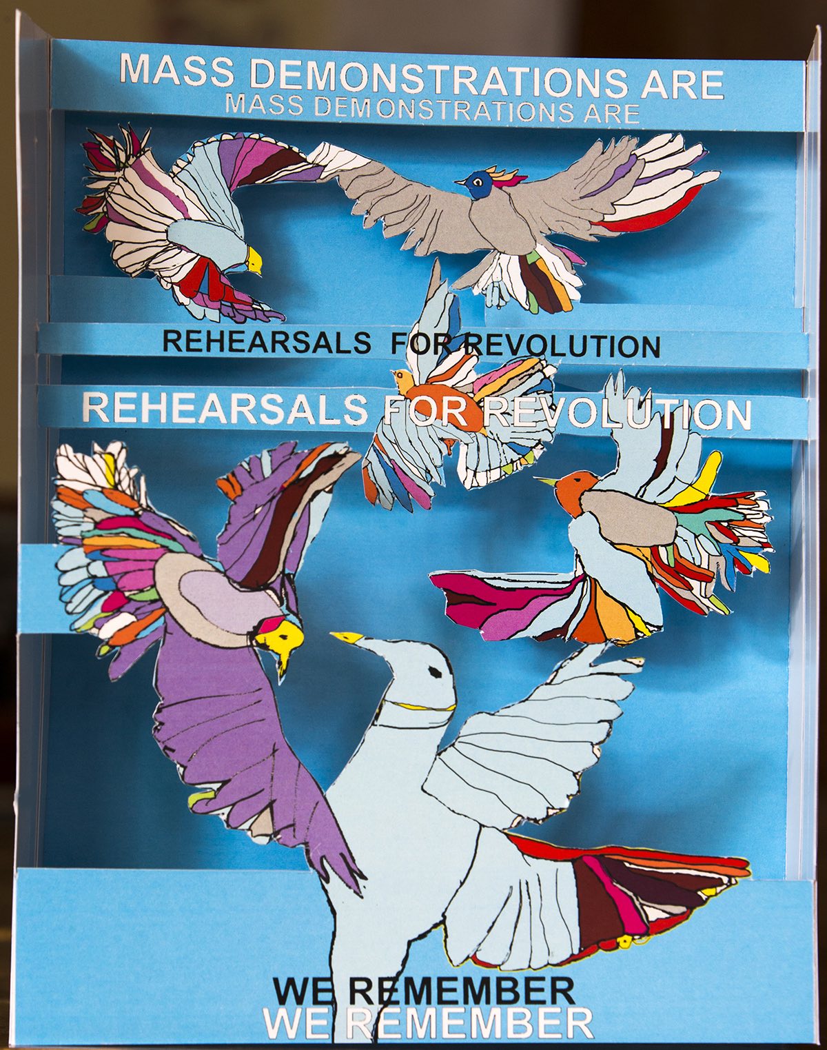Pop-up depicting birds with the text "Mass demonstrations are rehearsals for revolution."