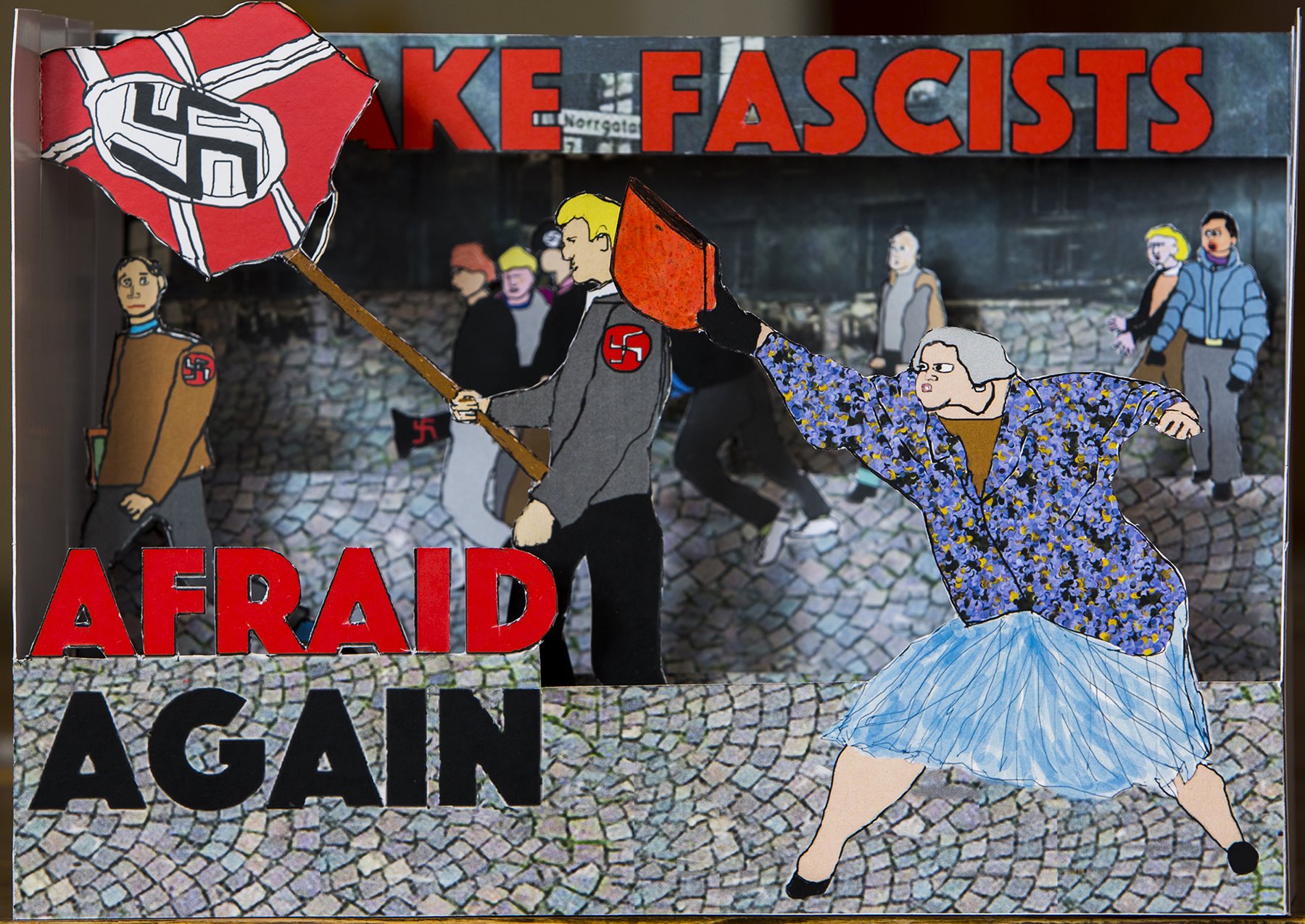 A pop-up depicting a woman hitting a neo-nazi in the head with a purse.